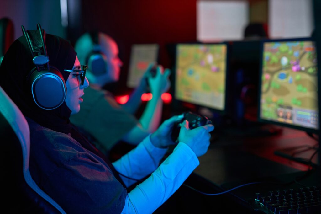 Muslim Woman Playing Videogames and Holding Gaming Controller